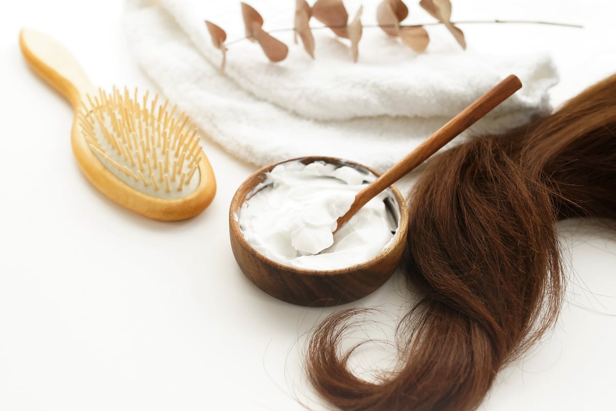 female hair, hair mask and bamboo comb on white background top view, flat lay. copy space. Self care, hair treatment  concept.