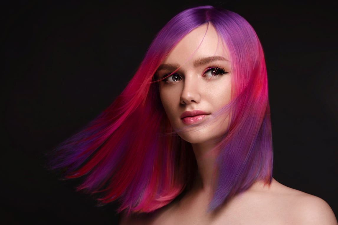 Beautiful woman with multi-colored hair and creative make up